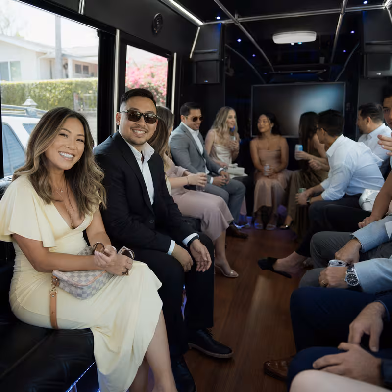Wedding guests seated inside a Orange party bus