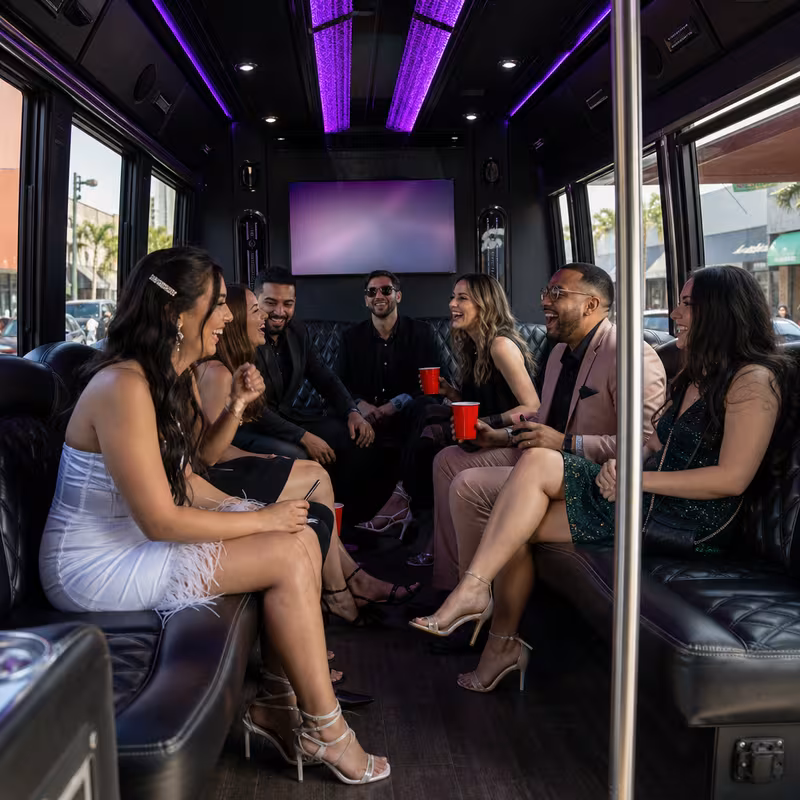 Party bus interior with wraparound leather seating and LED lighting in Orange