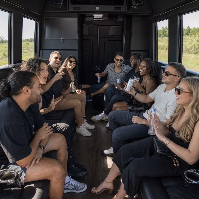 Group boarding a white charter bus for Concert Transportation transportation in Orange