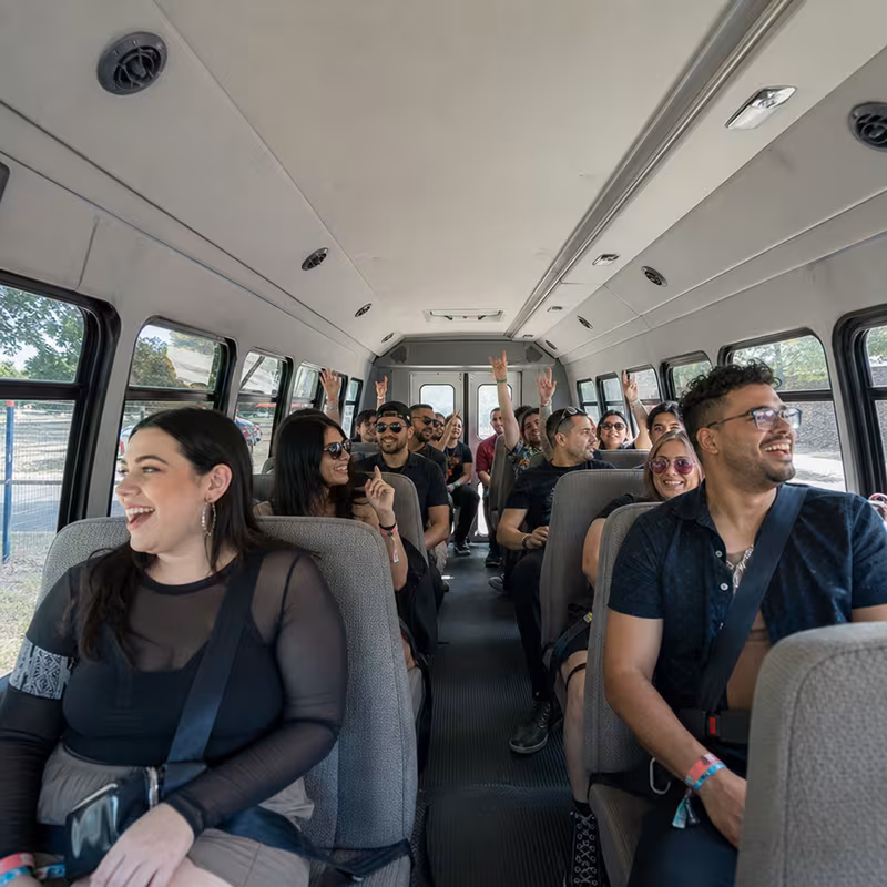 Party bus interior with wraparound leather seating and LED lighting in Orange
