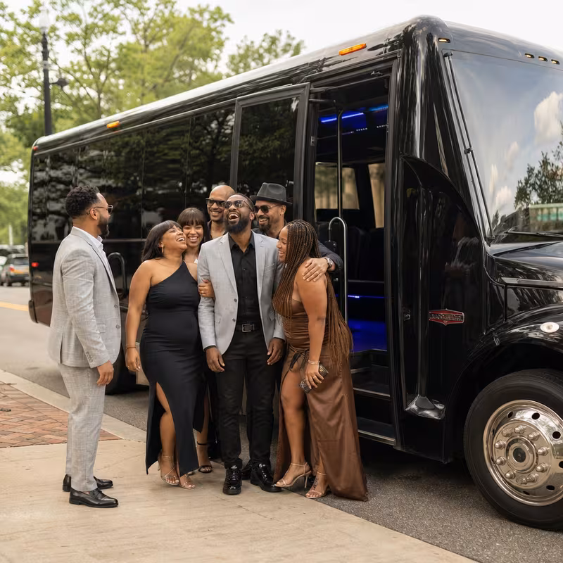 Passengers loading luggage while boarding an Orange group shuttle