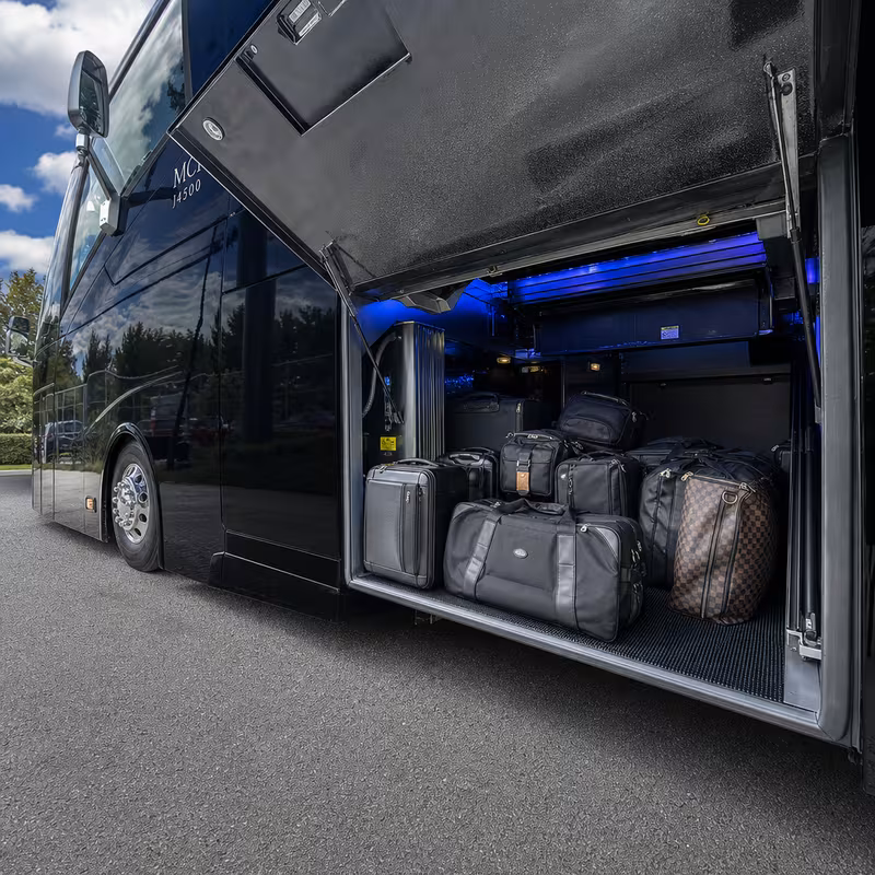 Party bus interior with wraparound leather seating and LED lighting in Orange