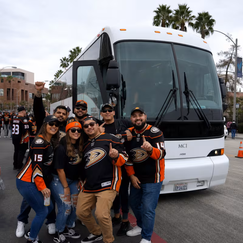 Passengers loading luggage while boarding an Orange group shuttle