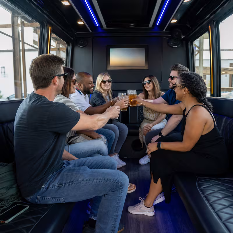 Group boarding a white charter bus for Winery & Brewery Tour Transportation transportation in Orange