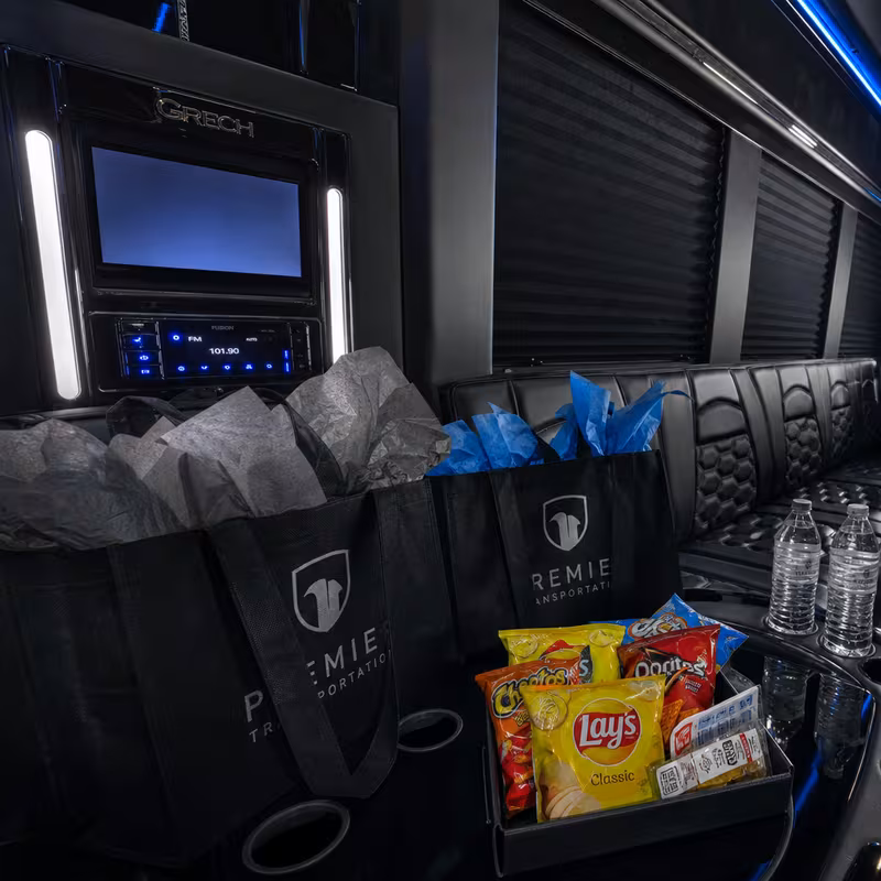 Party bus interior with wraparound leather seating and LED lighting in Orange